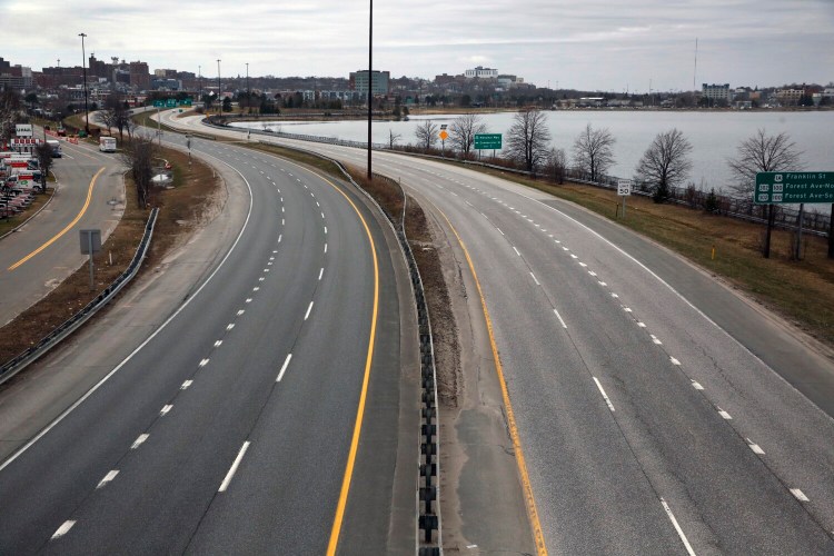 Interstate 295 in Portland is eerily empty at 10 a.m. Sunday, as viewed from the Washington Avenue overpass. Movement in densely populated urban areas of southern Maine has plummeted, while declines in some rural areas have been less pronounced.