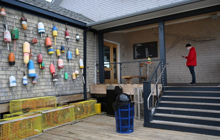 Justin Nilsen of North Yarmouth waits to pick up some food at Luke's Lobster in Portland Friday.