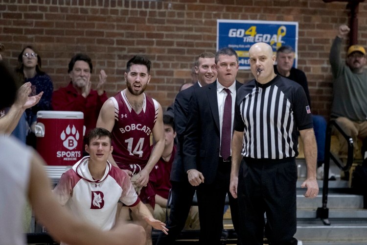 Bates College assistant men's basketball coach Sam Leal stands behind head coach Jon Furbush as they both watch the Bobcats take on Hamilton College in Lewiston last season.