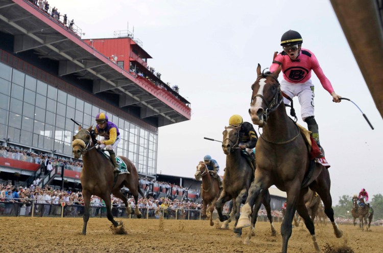 Jockey Tyler Gaffalione, right, reacts aboard War of Will, as they crosses the finish line first to win the Preakness Stakes in 2019 at Pimlico Race Course, in Baltimore. The race as been postponed to a to be determined date. 