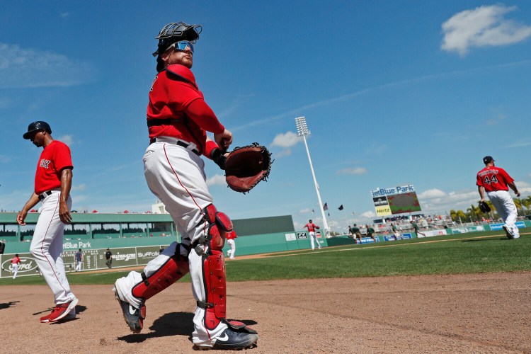 Boston Red Sox catcher Christian Vazquez takes the field on March 5 in Fort Myers, Florida. A reported proposal by Major League Baseball would make Fort Myers the Red Sox home this season if games are able to be played during the coronavirus pandemic.