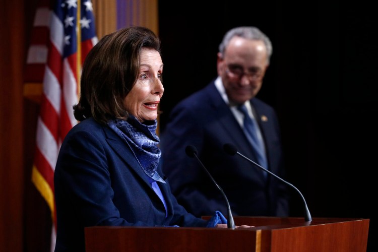 House Speaker Nancy Pelosi of California speaks with reporters alongside Senate Minority Leader Sen. Chuck Schumer of New York after the Senate approved a nearly $500 billion coronavirus aid bill on Tuesday on Capitol Hill in Washington. 