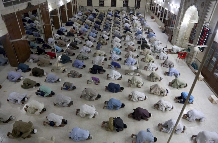 People attend evening prayers while maintaining a level of social distancing to help avoid the spread of the coronavirus, at a mosque in Karachi, Pakistan, on Sunday. In Maine, Muslims are finding creative ways to observe both their faith and the public health guidelines related to coronavirus during Ramadan.