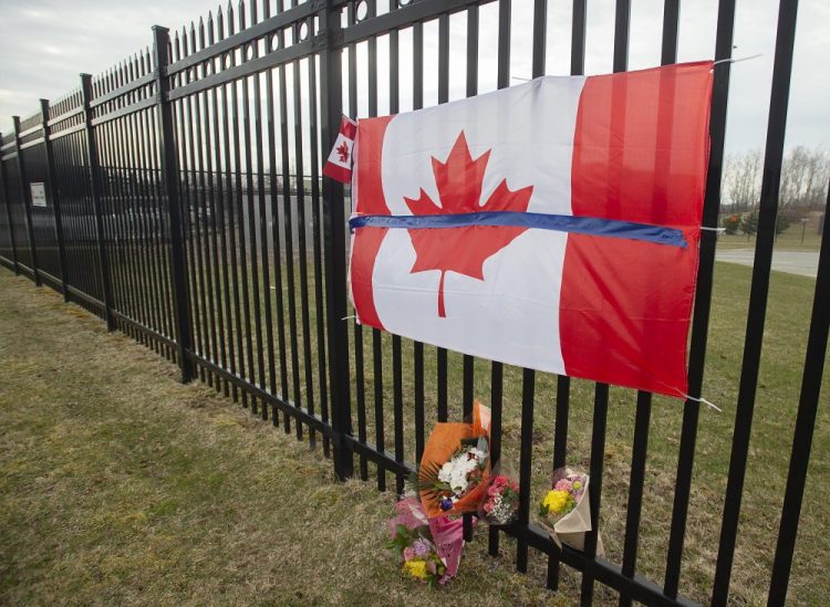 A tribute is displayed Monday at the Royal Canadian Mounted Police headquarters in Dartmouth, Nova Scotia, following a weekend shooting rampage by a gunman, disguised as a police officer, that killed at least 23 people including an RCMP constable.  