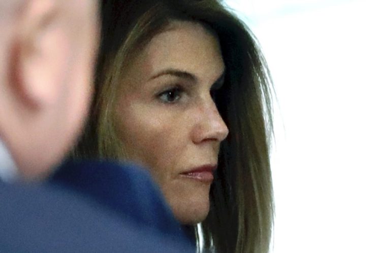 Lori Loughlin enters federal court in Boston Aug. 27 for a hearing in a nationwide college admissions bribery scandal. 