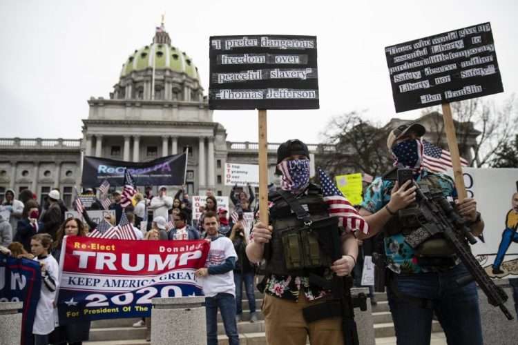 Protesters demonstrate Monday at the state Capitol in Harrisburg, Pa., demanding that Gov. Tom Wolf reopen Pennsylvania's economy even as new social-distancing mandates took effect at stores and other commercial buildings. 