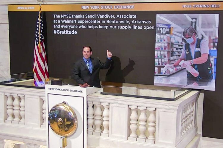 Kevin McSpedon, assistant chief electrician, rings the opening bell at the New York Stock Exchange, recognizing Sandi Vandiver, associate at a Walmart Supercenter in Bentonville, Arkansas, on Wednesday.