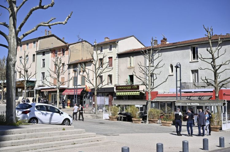 Police officers patrol after a man wielding a knife attacked residents venturing out to shop in the town under lockdown, Saturday  in Romans-sur-Isere, southern France. The alleged attacker was arrested by police nearby, shortly after the attack. 