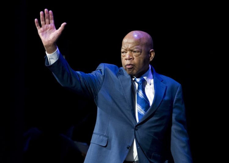 FILE- In this Jan. 3, 2019, file photo, Rep. John Lewis, D-Ga., waves to the audience during swearing-in ceremony of Congressional Black Caucus members of the 116th Congress in Washington. The NAACP honored Lewis for his Congressional service and long history as a civil rights activist.