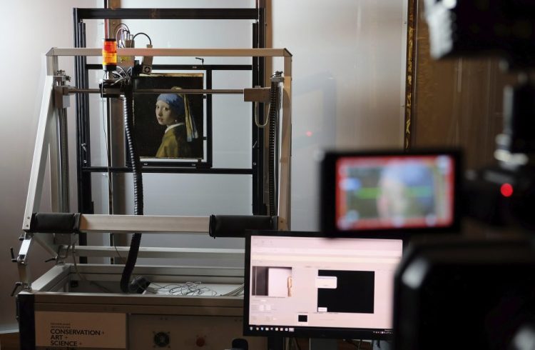 In this file photo dated Monday, Feb. 26, 2018, a macro XRF scanner is used to study in minute detail the surface of Johannes Vermeer's 17th century masterpiece "Girl with a Pearl Earring", at the Mauritshuis museum in The Hague, Netherlands. 