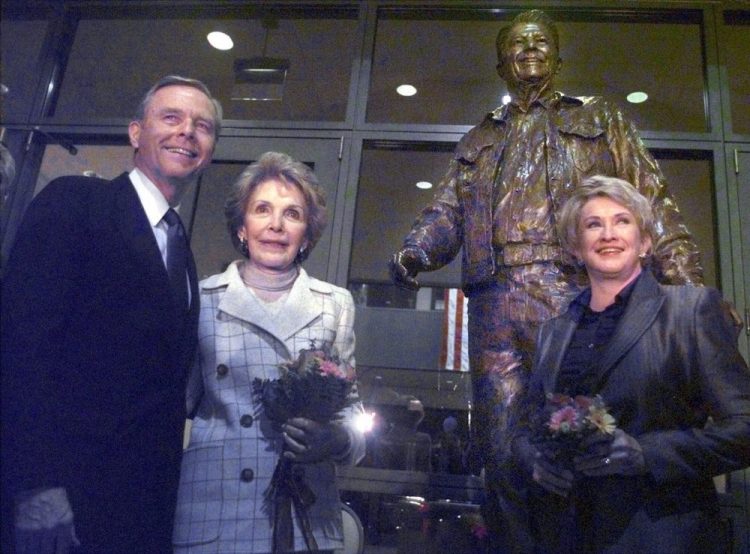 From left, California Gov. Pete Wilson, Nancy Reagan and sculptor Glenna Goodacre stand in front of "After the Ride," a bronze sculpture of Ronald Reagan in 1998, in front of the main entrance to the Ronald Reagan Presidential Library in Simi Valley, Calif., after the statue's unveiling.