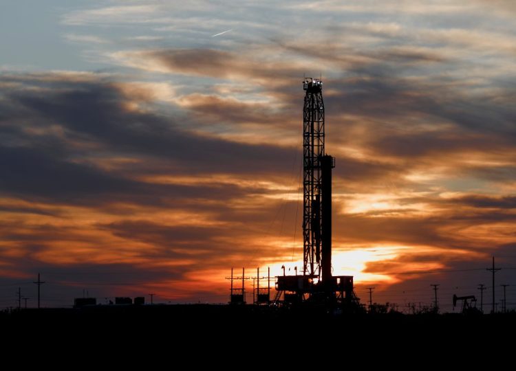 An oil rig stands against the setting sun in Midland, Texas on Friday, April 17.