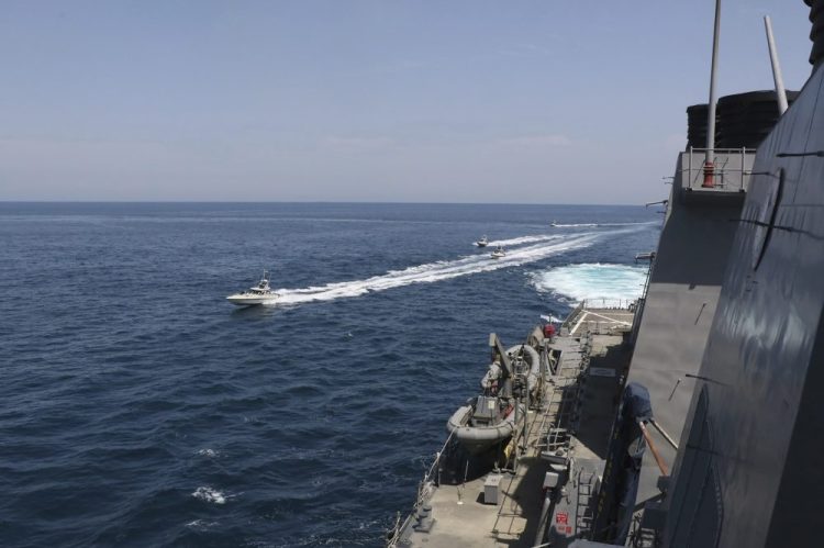 Iranian Revolutionary Guard vessels sail close to U.S. military ships April 15 in the Persian Gulf near Kuwait. A group of 11 Iranian naval vessels made "dangerous and harassing" maneuvers near U.S. ships in the Persian Gulf, in one case passing within 10 yards of a U.S. Coast Guard cutter, U.S. officials said.