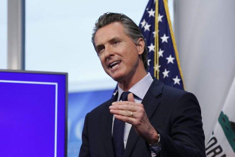 California Gov. Gavin Newsom discusses an outline for what it will take to lift coronavirus restrictions during a news conference Tuesday at the Governor's Office of Emergency Services in Rancho Cordova.
