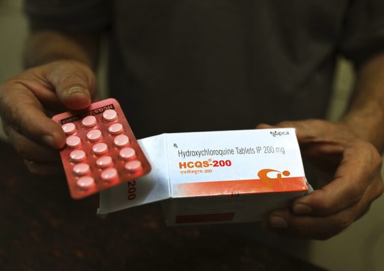 FILE - In this Thursday, April 9, 2020 file photo, a chemist displays hydroxychloroquine tablets in New Delhi, India. Scientists in Brazil have stopped part of a study of the malaria drug touted as a possible coronavirus treatment after heart rhythm problems developed in one-quarter of people given the higher of two doses being tested. Chloroquine and a similar drug, hydroxychloroquine, have been pushed by President Donald Trump after some early tests suggested the drugs might curb coronavirus entering cells.  (AP Photo/Manish Swarup, File)