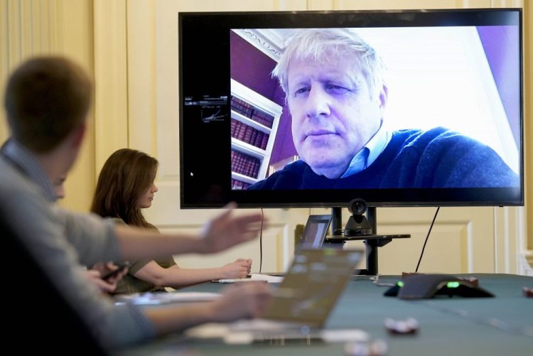 Britain's Prime Minister Boris Johnson chairs the morning COVID-19 meeting remotely while self-isolating after testing positive for the coronavirus, at 10 Downing Street, London, on Saturday. Johnson was admitted to a hospital on Sunday and moved to the intensive care unit on Monday.
