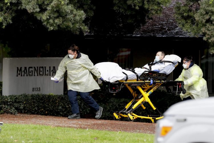 A patient is evacuated from the Magnolia Rehabilitation and Nursing Center in Riverside, Calif., on Wednesday. Experts say nursing home deaths may keep climbing because of chronic staffing shortages. 