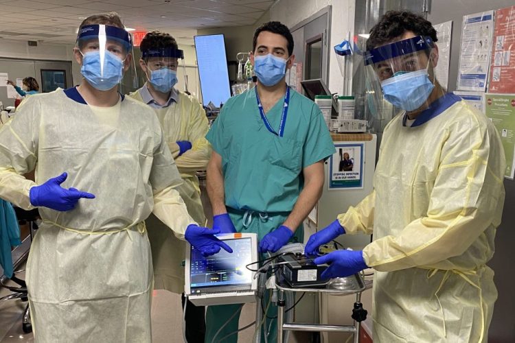 From left, Drew Copeland, RPSGT; Dr. Thomas Tolbert; Dr. Brian Mayrsohn, and Dr. Hooman Poor stand with a ventilator prototype they developed from a sleep apnea machine at Mount Sinai hospital in New York.
