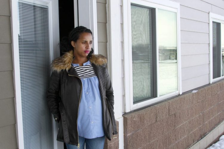 Kulule Amosa steps out of the apartment she shares with her husband who works at the Smithfield Foods pork processing plant in Sioux Falls, S.D. He tested positive for the coronavirus this week after an outbreak at the plant. 