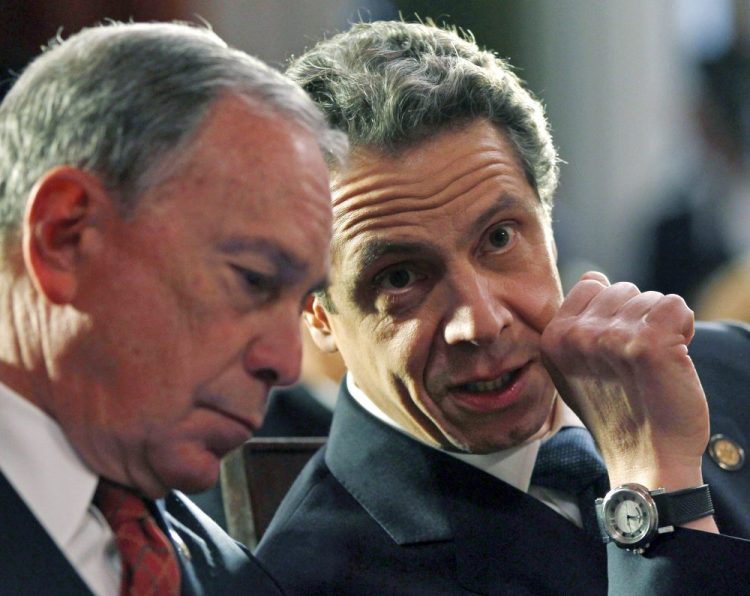 Then-New York Mayor Michael Bloomberg, left, and New York Gov. Andrew Cuomo on March 16, 2012, at the Capitol, in Albany, N.Y.  Bloomberg will help create a "tracing army" that will help find people infected with the coronavirus and get them into isolation, Cuomo announced Wednesday.