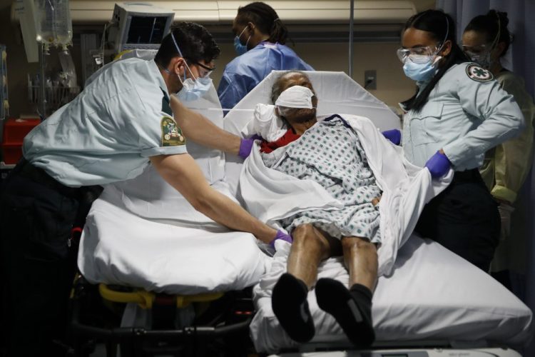 Emergency medical technicians transport a patient from a nursing home to an emergency room bed at St. Joseph's Hospital in Yonkers, N.Y., on April 20.  The White House is now recommending testing at nursing homes.