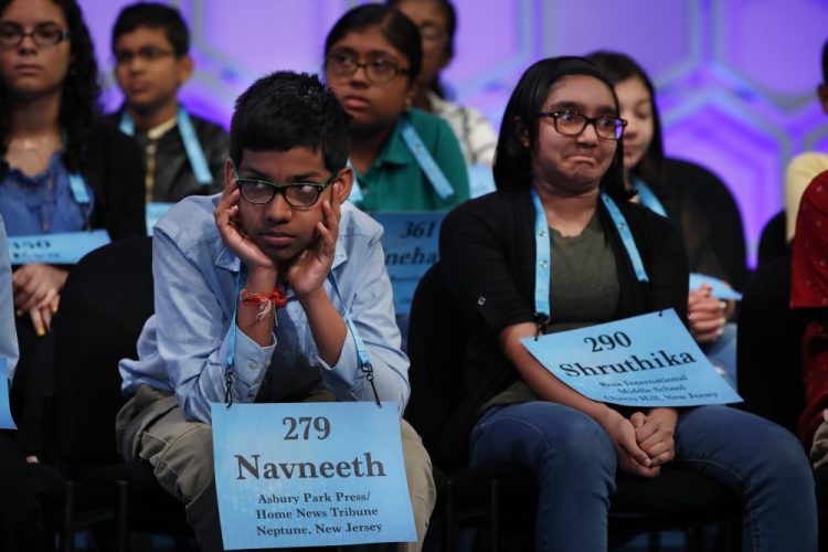 Navneeth Murali, 12, of Edison, N.J., left, and Shruthika Padhy, 12, of Cherry Hill, N.J., react during the Scripps National Spelling Bee on May 31, 2018, in Oxon Hill, Md.,  With the 2020 Scripps National Spelling Bee canceled because the coronavirus pandemic, an online spelling bee launched by two Texas teenagers is offering a consolation prize of sorts, with competitors nationwide including many of the kids who were considered favorites for the Scripps title.