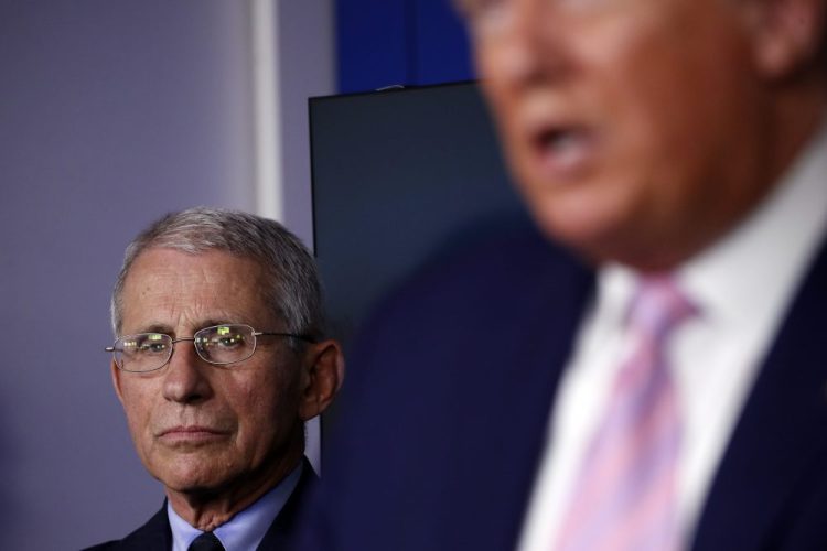 Dr. Anthony Fauci, director of the National Institute of Allergy and Infectious Diseases, listens as President Donald Trump speaks about the coronavirus in the James Brady Press Briefing Room of the White House, Wednesday, April 1.