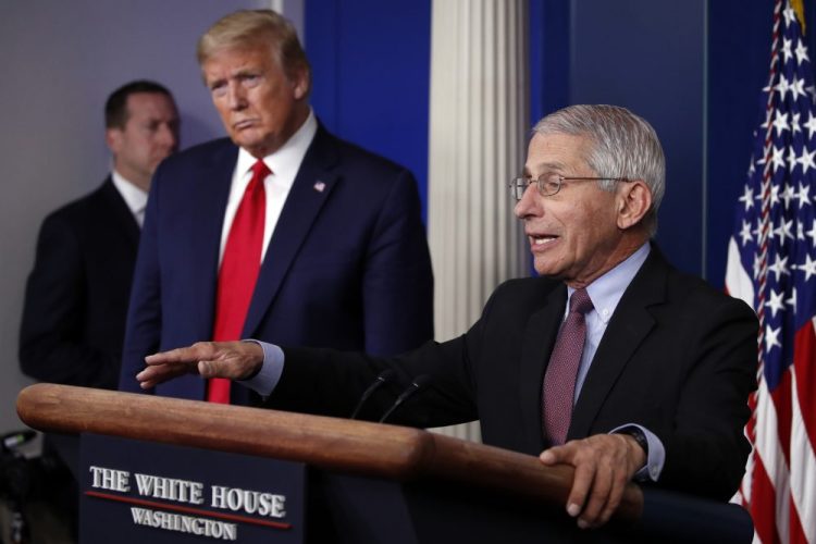 President Trump listens as Dr. Anthony Fauci, director of the National Institute of Allergy and Infectious Diseases, speaks about the coronavirus in the James Brady Press Briefing Room of the White House on April 22.
