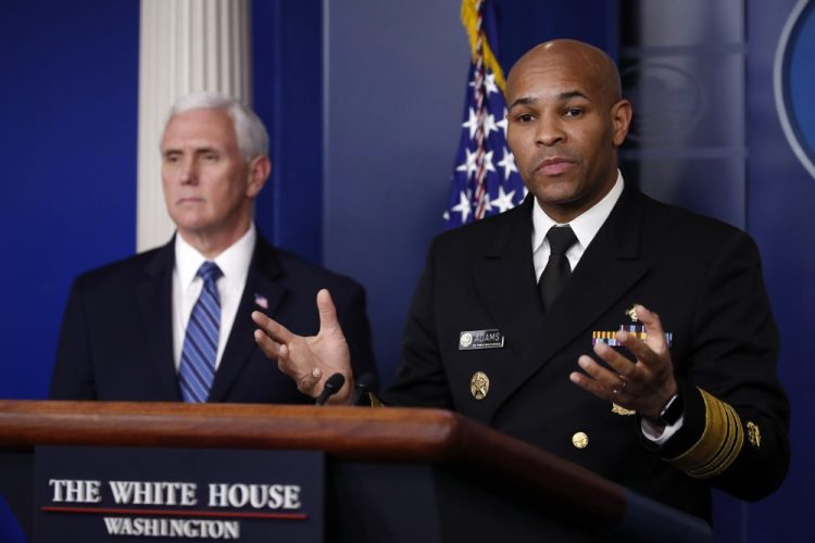 U.S. Surgeon General Jerome Adams speaks about the coronavirus in the James Brady Press Briefing Room of the White House on Friday in Washington, as Vice President Mike Pence listens.