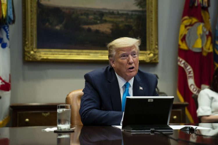 President Trump during a conference call with banks on efforts to help small businesses during the coronavirus pandemic on Tuesday. The Defense Department revealed that Trump removed acting inspector general Glenn Fine from his role as head of a coronavirus spending oversight board.