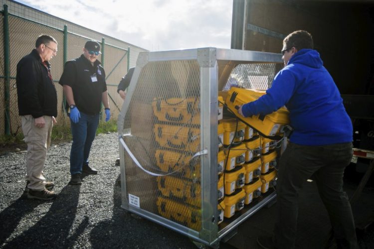 Officials at the Yakima Valley Office of Emergency Management evaluate how many ventilators arrived from the weekly supply shipment Thursday in Union Gap, Wash.