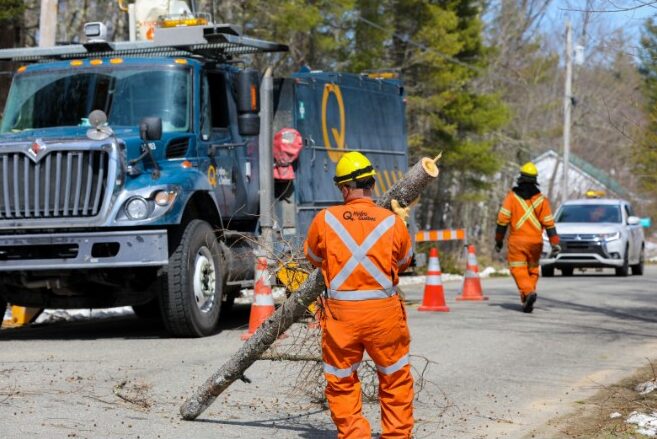 A repair crew sent to Maine by Hydro-Quebec works to restore power near Belfast on Sunday.