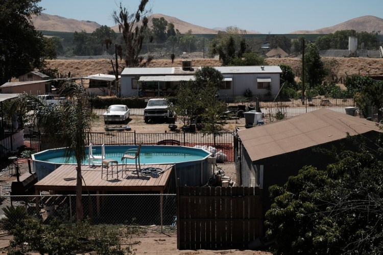 A swimming pool contrasts with the drought dried landscape in East Porterville, Calif., in 2015. With access to water limited, the pool's owner doesn't drain it, instead using chemicals to keep it clean.