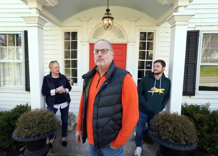 Liz and Ken Frydman and their son Beau stand in front of their country home in Sharon, Conn. They left their Manhattan apartment as the coronavirus ravaged New York and are staying in Connecticut full time. 