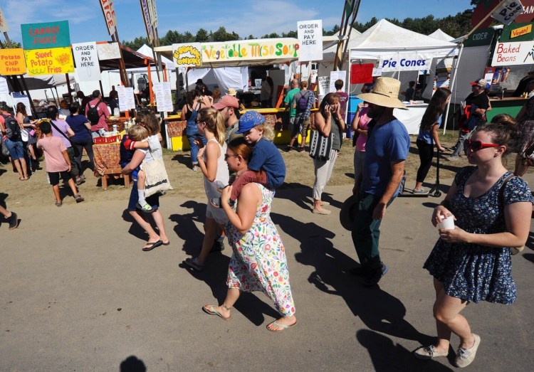 Fair goers line the walkway during the Common Ground Country Fair in Unity last year.