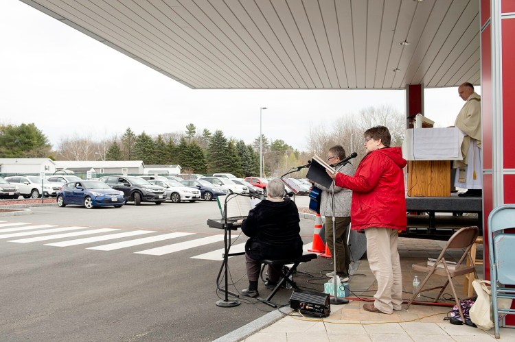 Sister Monique Belanger, left, Anne Marie Gagnon and Joline Laliberte play hymns during the Prince of Peace Parish parking lot mass at Geiger in Lewiston on Sunday.