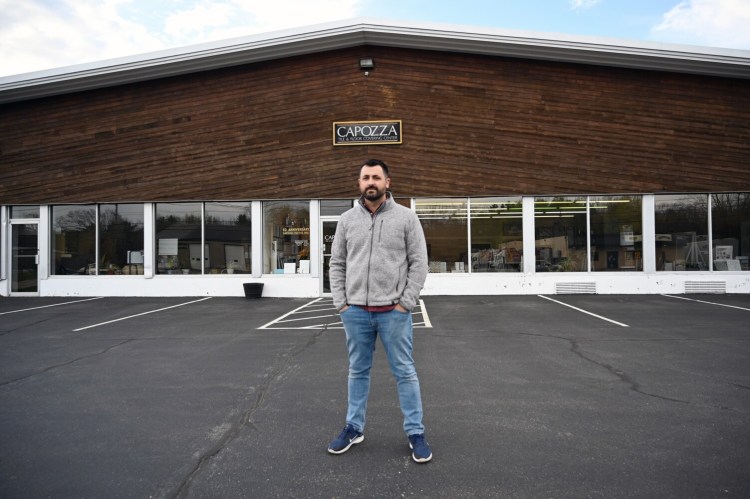 Joe Capozza of Capozza Tile and Flooring Center in Portland stands in front of his business Wednesday. Capozza has used the federal Paycheck Protection Program to help his business. Others have opted out because they believe the terms wold not work for them.