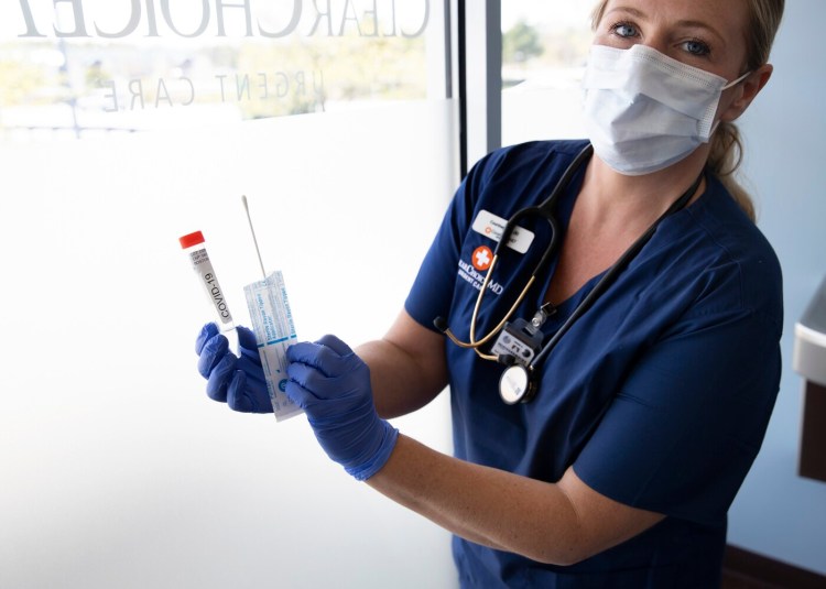 ClearChoiceMD Urgent Care is offering COVID-19 testing for active infection and for antibodies. Radiology technician Courtney Bell holds a testing swab and a collection tube Thursday for the active infection test.