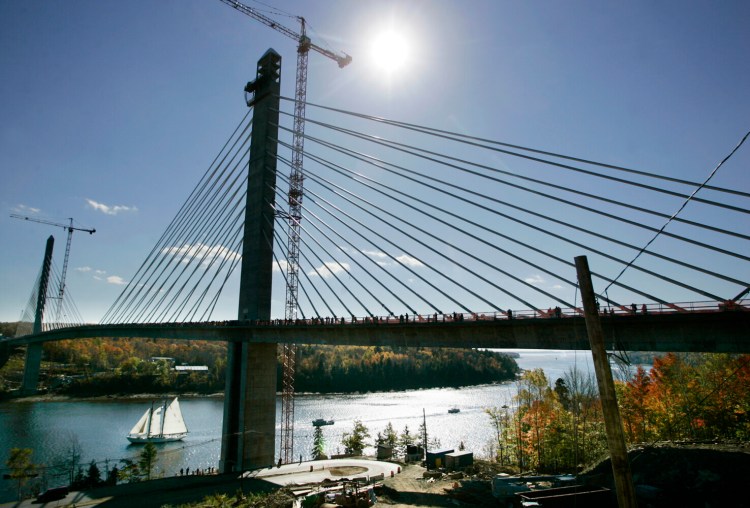 A large sailboat leads a boat parade under the Penobscot Narrows Bridge and Observatory, Oct. 14, 2006, during Bridgewalk, a celebration of the newly constructed bridge.