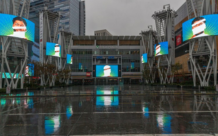 Video screens show images of Los Angeles Lakers' Anthony Davis in a plaza across from Staples Center, home of two NBA teams, an NHL team and a WNBA team, in Los Angeles. There's a clear desire for basketball to resume but, perhaps mindful of how rushing back too quickly hurt other leagues around the world, the NBA seems to be taking very cautious baby steps back to the court. 