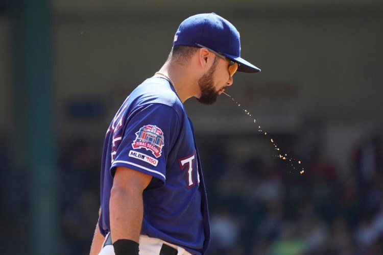 Texas Rangers third baseman Isiah Kiner-Falefa lets some salvia fly during a game in 2019. Spitting, long a part of all sports, but especially baseball. will likely become a thing of the past because of the coronavirus.