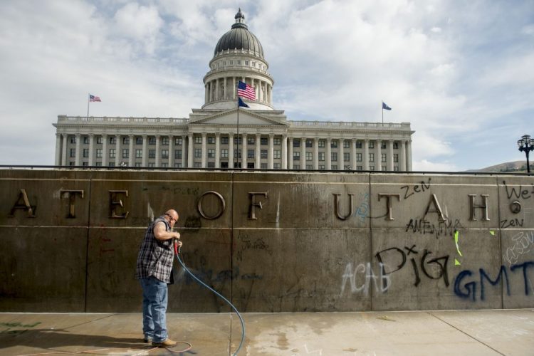 Don Gamble cleans up graffiti at the Capitol in Salt Lake City on Sunday, following protests over the death of George Floyd. Protests were held throughout the country over the death of Floyd, a black man who died after being restrained by Minneapolis police officers on May 25.