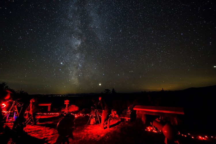 The naturally dark night sky at Katahdin Woods and Waters National Monument has become a draw for visitors at the northern-Maine monument, as shown above at the annual "Stars over Katahdin" event. 
