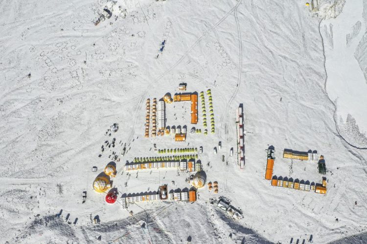 In this April 30, 2020, aerial photo released by China's Xinhua News Agency, vehicles and tents are seen at the base camp at the foot of the peak of Mount Qomolangma, also known as Mount Everest, in southwestern China's Tibet Autonomous Region. 