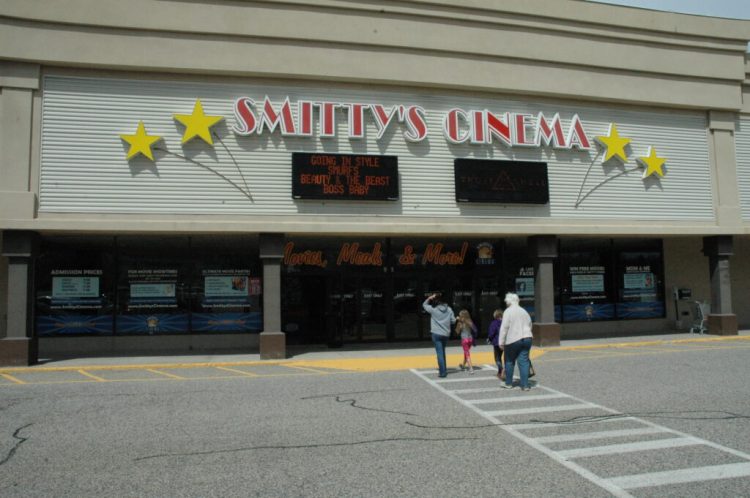 A group goes into Smitty's Cinema in Biddeford on April 18, 2017. The cinema is now shutting down because of the loss of business during the coronavirus pandemic.