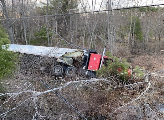 The tractor-trailer that crashed early Monday came to rest about 75 feet from Route 302 on the bank of Dead Lake Stream.