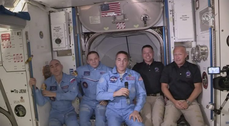 Bob Behnken and Doug Hurley, far right, join the the crew at the International Space Station, after the SpaceX Dragon capsule pulled up to the station and docked Sunday. The Dragon capsule arrived Sunday morning, hours after a historic liftoff from Florida. It's the first time that a privately built and owned spacecraft has delivered a crew to the orbiting lab.