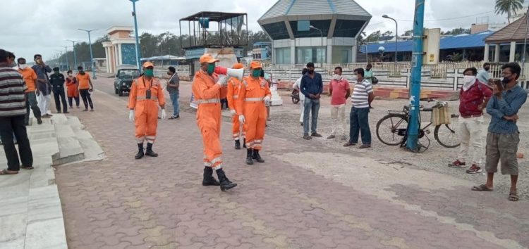 India's National Disaster Response Force warn people on the Bay of Bengal coast about Cyclone Amphan on Tuesday. The powerful cyclone is moving toward India and Bangladesh and expected to hit Wednesday.