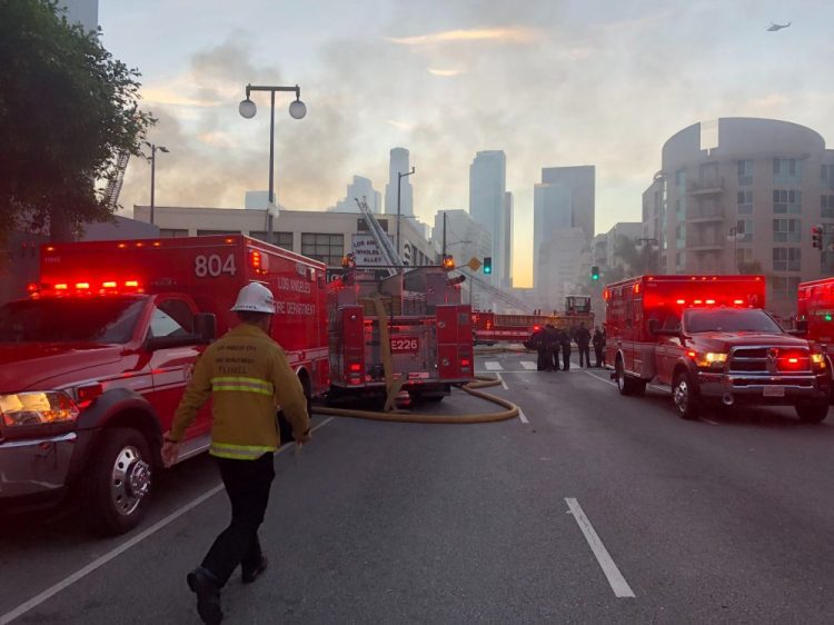 Firefighters respond to an explosion in downtown Los Angeles that has injured multiple firefighters and caused a fire that spread to several buildings Saturday in Los Angeles.