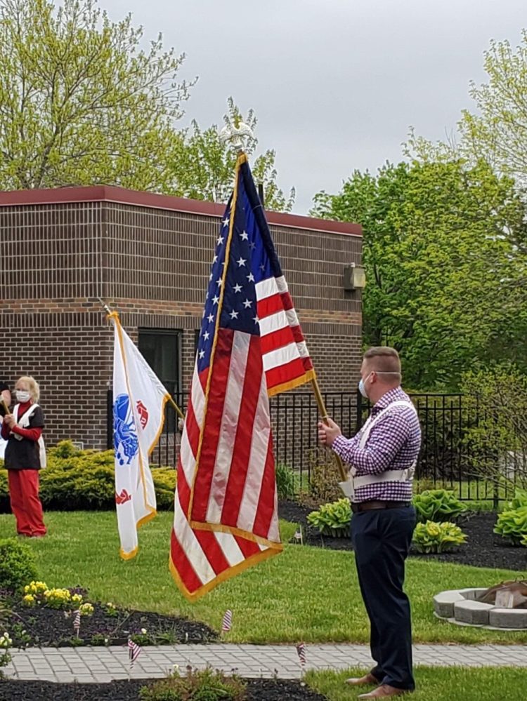 Jake Anderson, administrator at Maine Veterans’ Homes — Augusta, participates in the presentation of flags for a Memorial Day Ceremony.